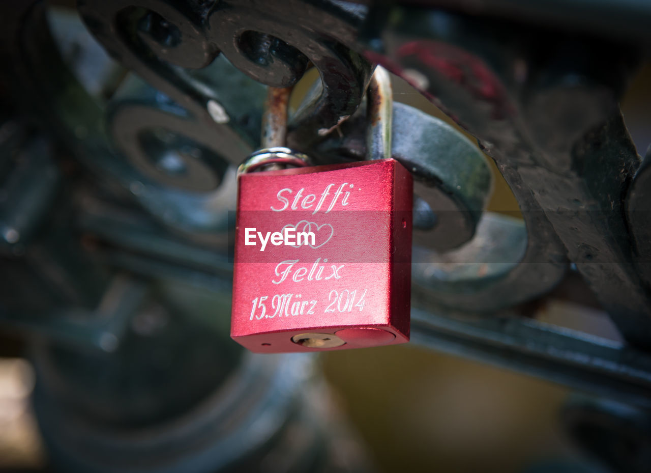 Close-up of love padlock on metallic fence