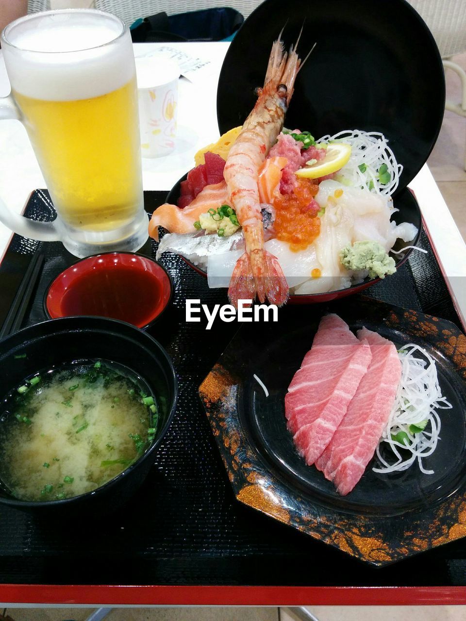 High angle view of food served with beer in tray on table