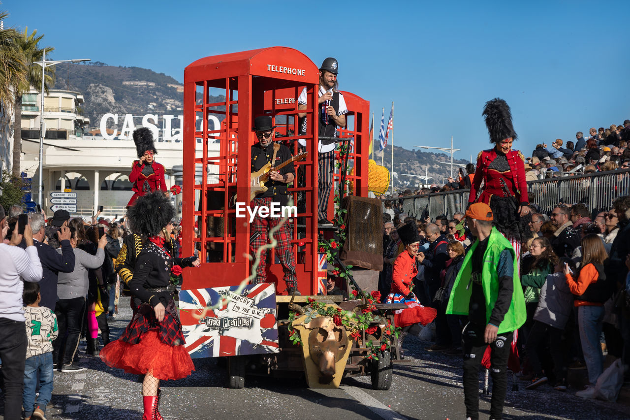 group of people, crowd, city, architecture, festival, large group of people, sky, men, nature, arts culture and entertainment, adult, street, building exterior, person, transportation, outdoors, event, tradition, celebration, built structure, women, day, clothing