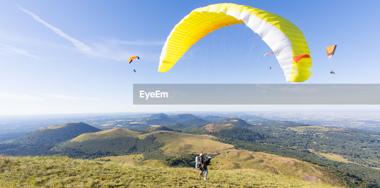 Paragliding at the top of the puy de dome in front of the puys chain in auvergne