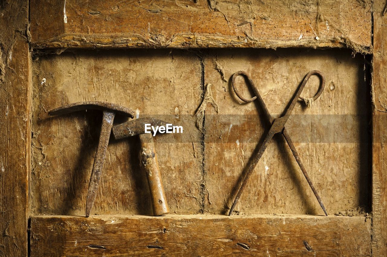 Close-up of carpentry tools on dirty wooden niche