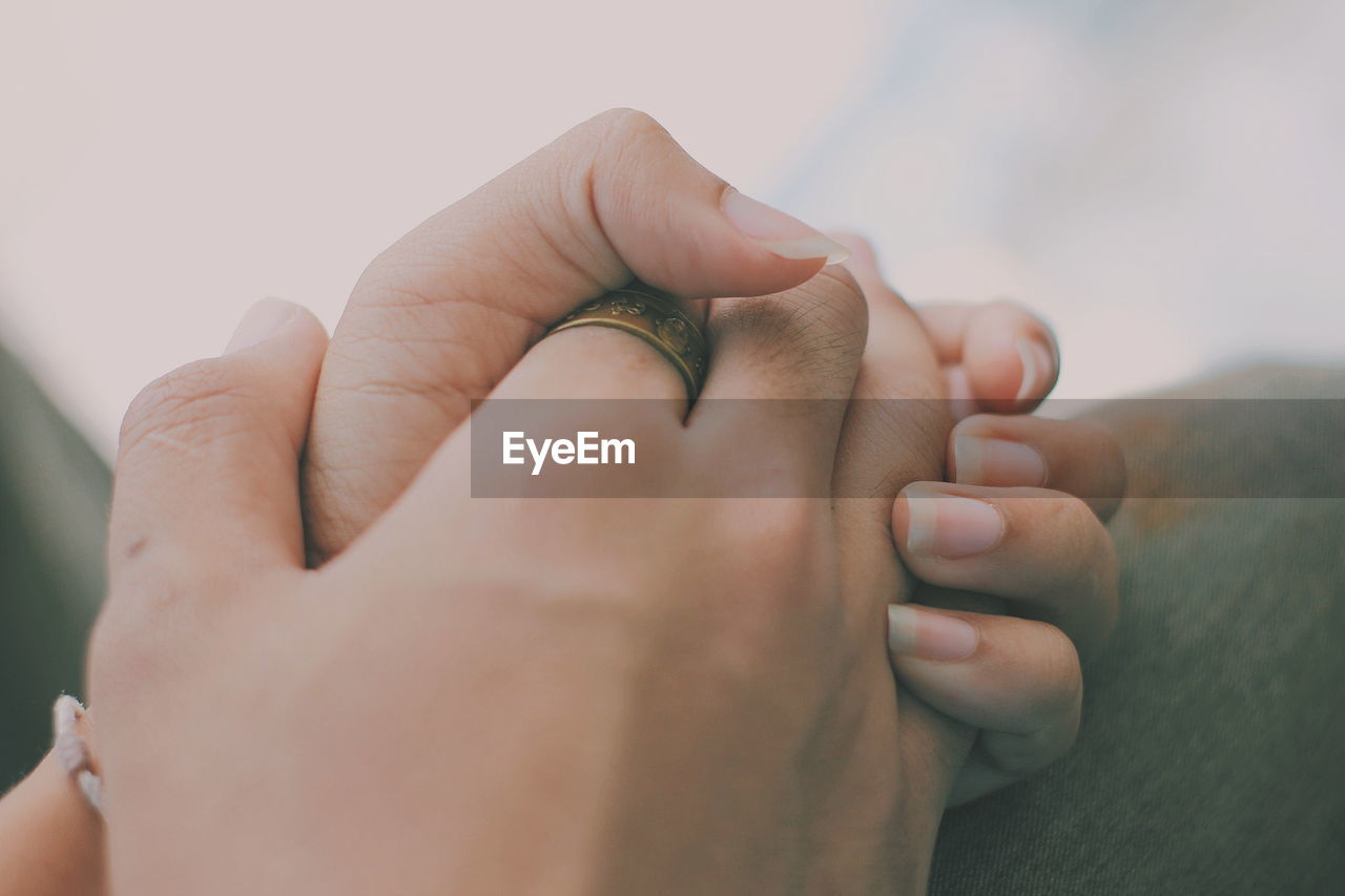 Close-up of couple holding hands