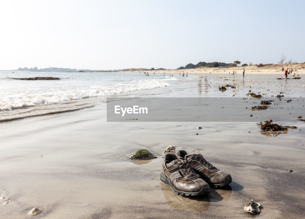 Image of the traveler's pair of shoes on a beach in brittany.