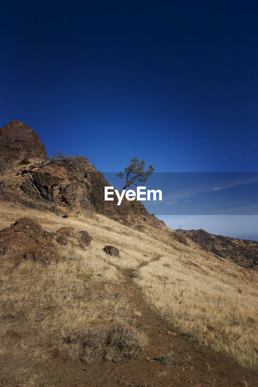 Scenic view of mountains against clear blue sky