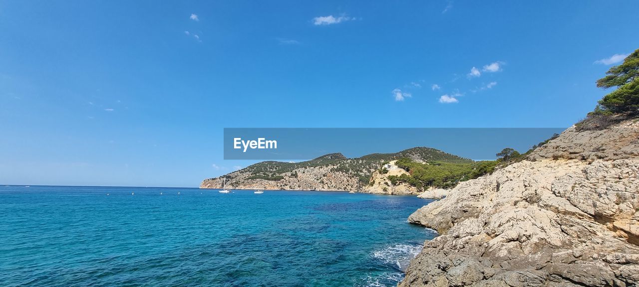water, sea, sky, scenics - nature, land, beauty in nature, nature, blue, beach, vacation, travel destinations, travel, ocean, rock, tranquility, tranquil scene, coast, body of water, cloud, coastline, mountain, shore, idyllic, no people, tourism, environment, holiday, landscape, day, trip, island, outdoors, cliff, horizon, horizon over water, islet, cove, non-urban scene, summer, seascape, tropical climate, terrain, clear sky, bay, sunny, tree, lagoon, turquoise colored, sunlight, bay of water