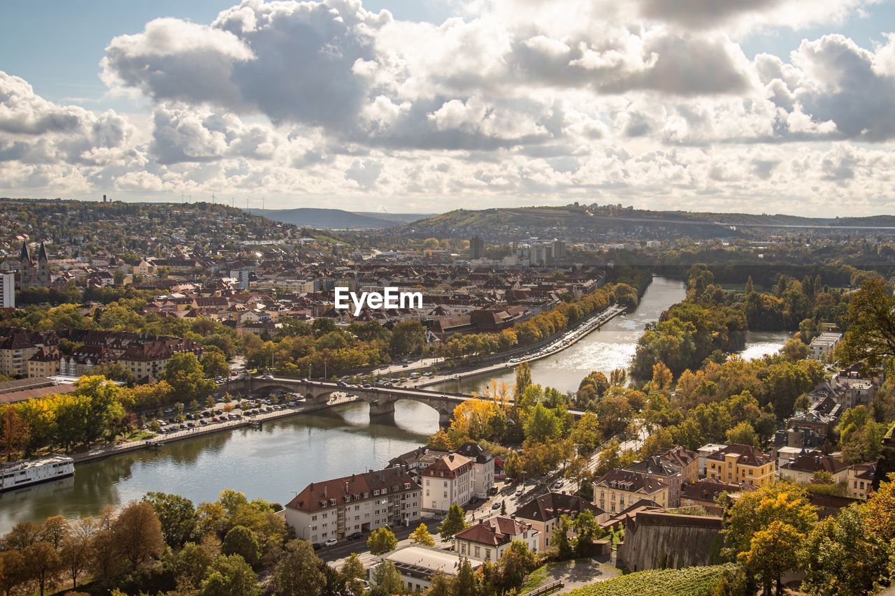 High angle view of river amidst buildings against sky