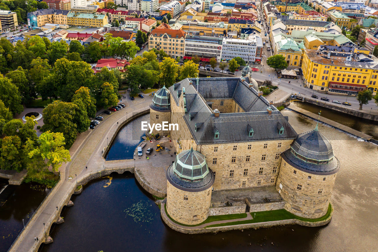 High angle view of buildings and trees in city