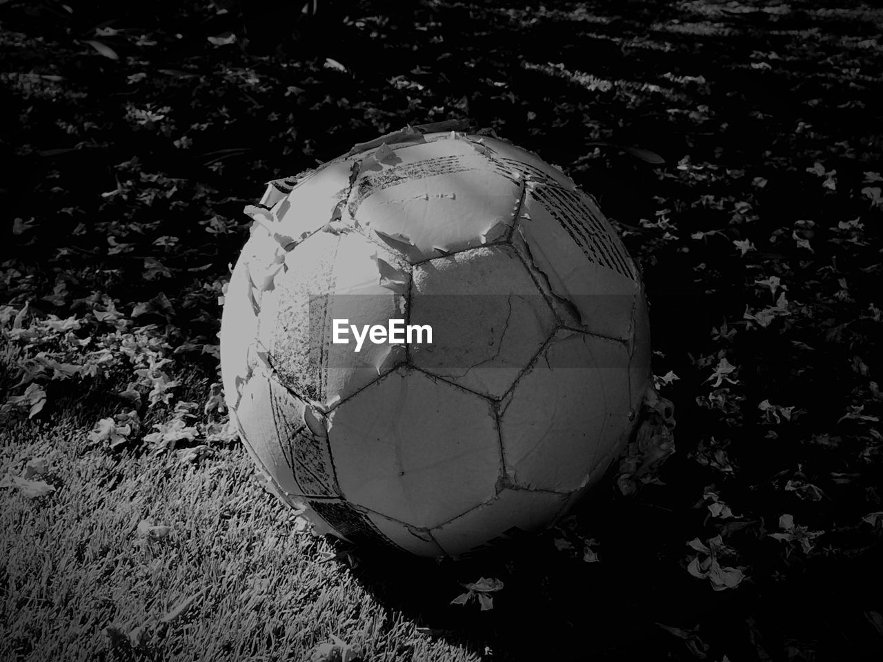 High angle view of weathered soccer ball