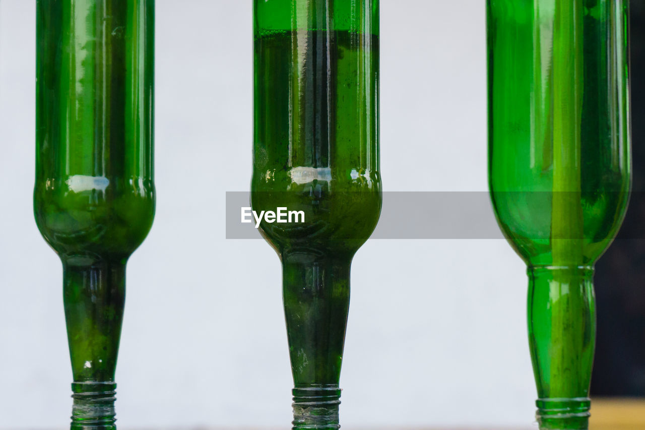 Close-up of green glass against white background