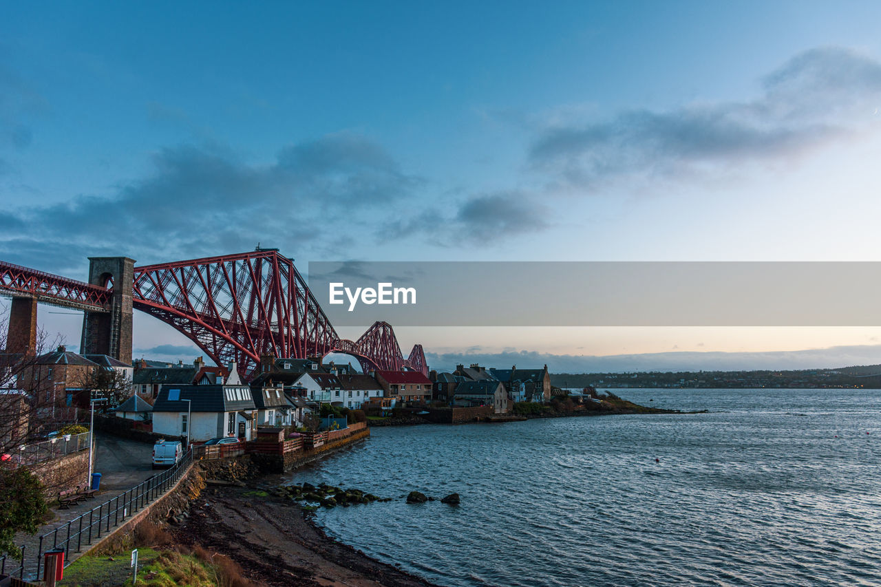 View of bridge over sea against cloudy sky