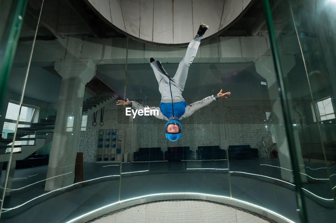 A woman flies in a wind tunnel. free fall simulator