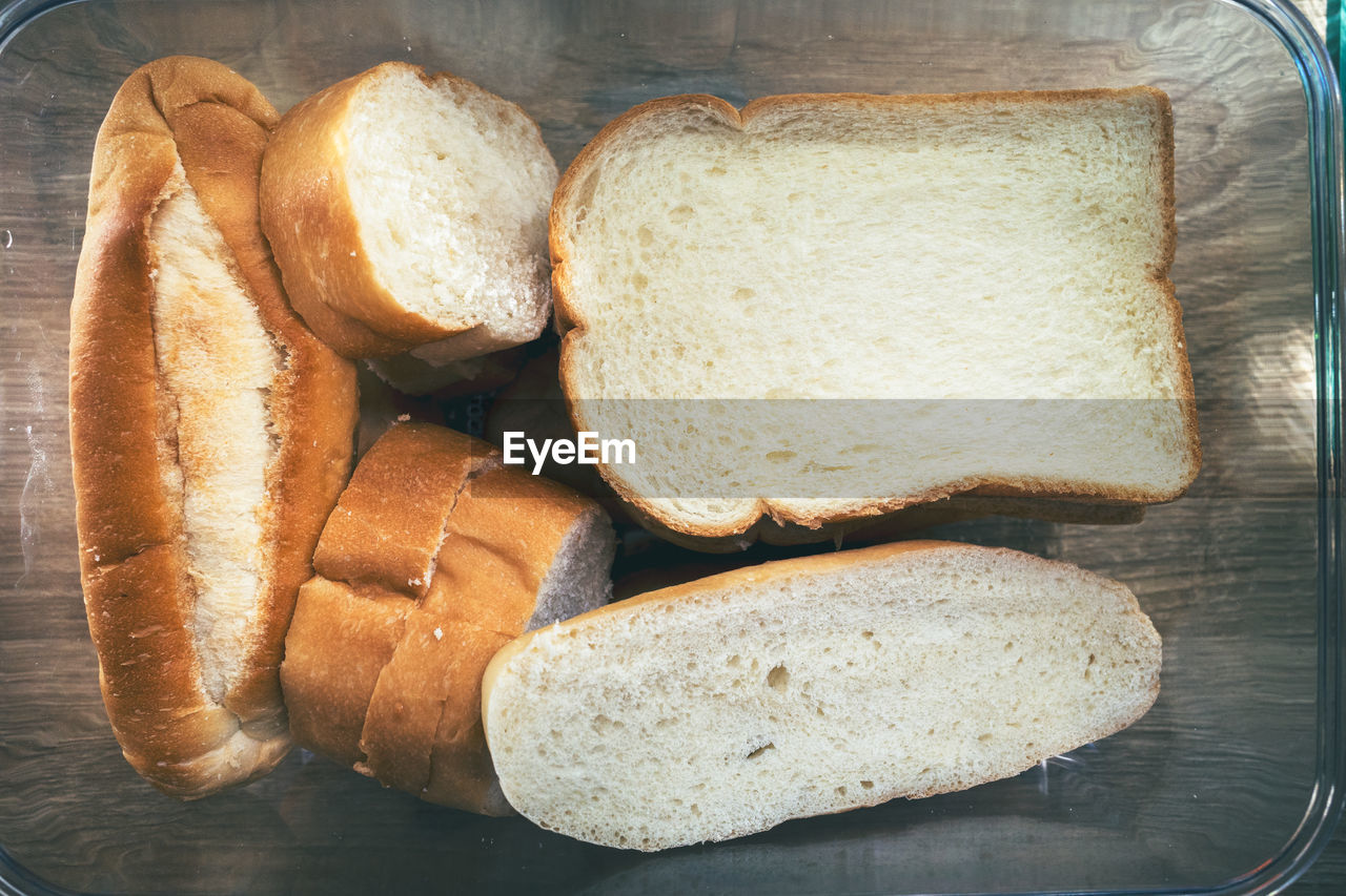 HIGH ANGLE VIEW OF BREAD WITH MEAT AND KNIFE