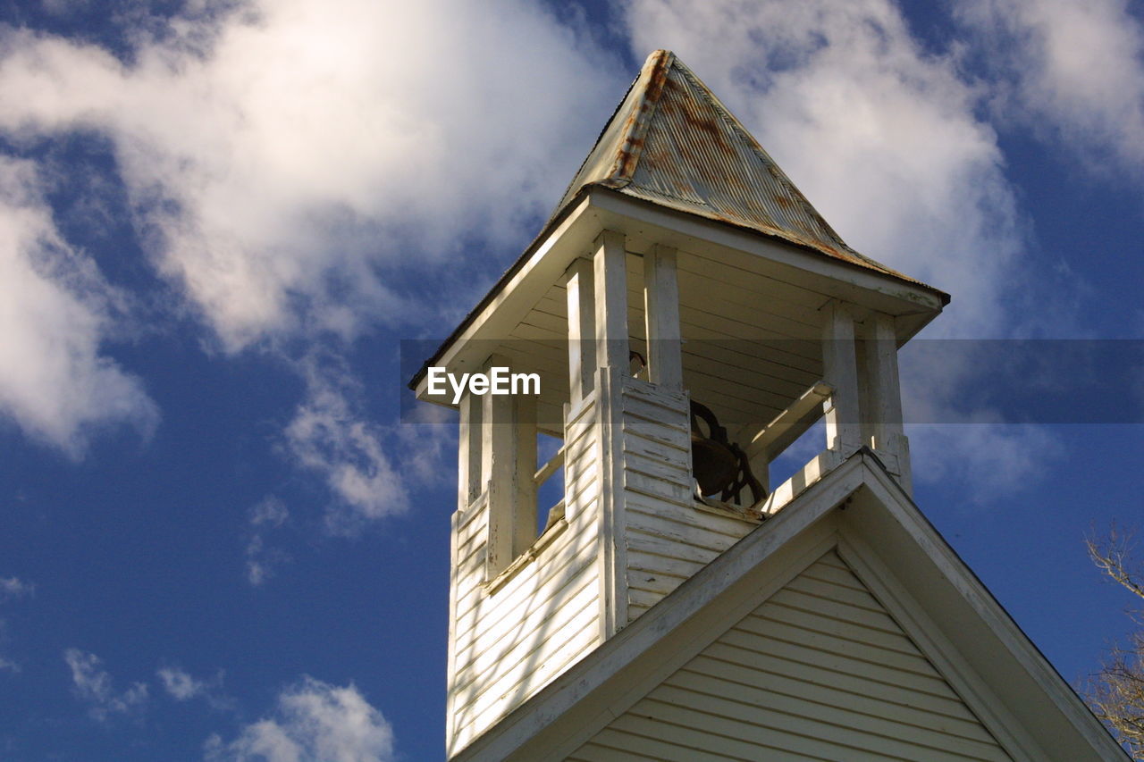 Low angle view of bell tower against sky