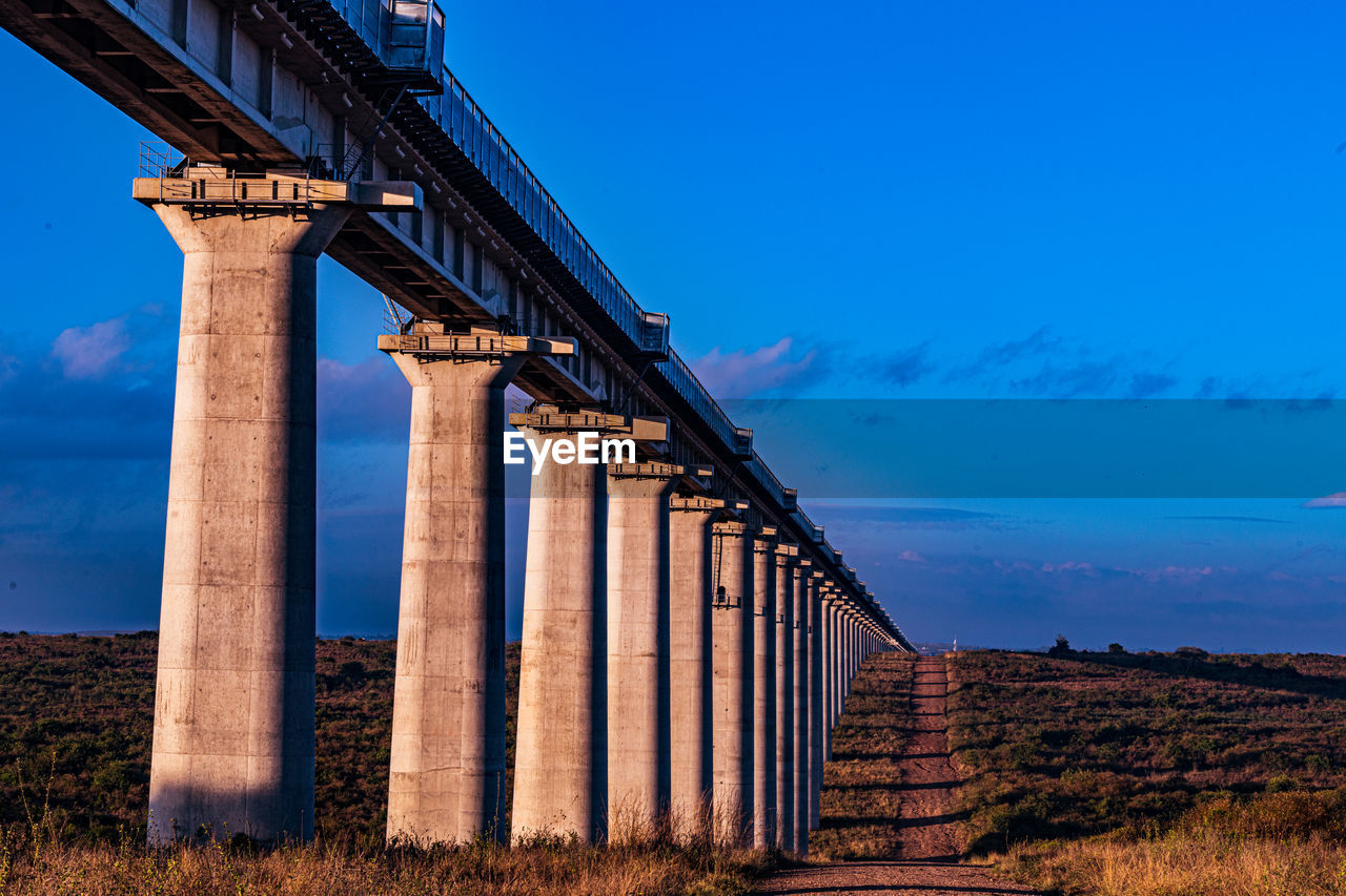 low angle view of bridge against blue sky