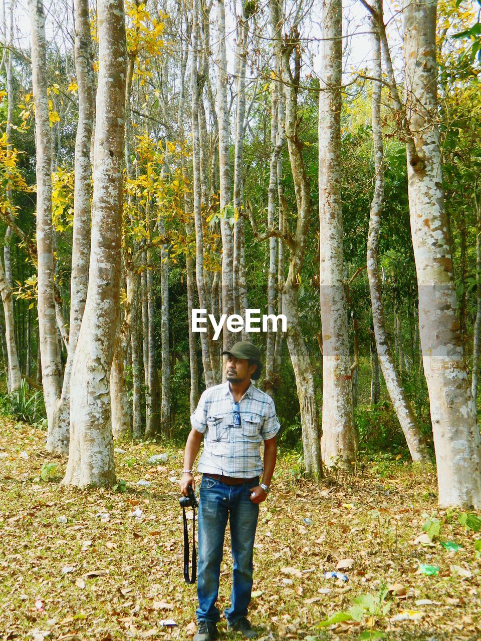 WOMAN STANDING IN FOREST