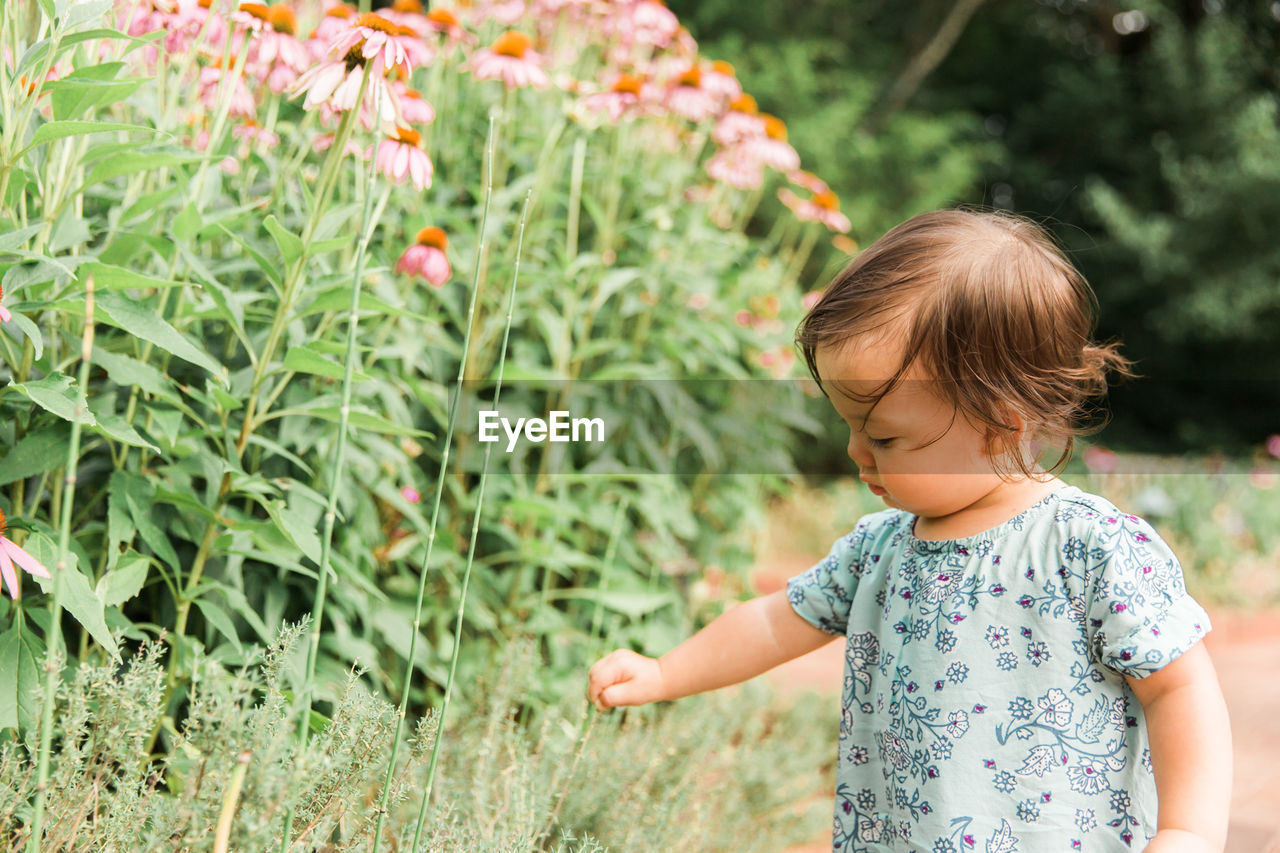 Girl standing by plants