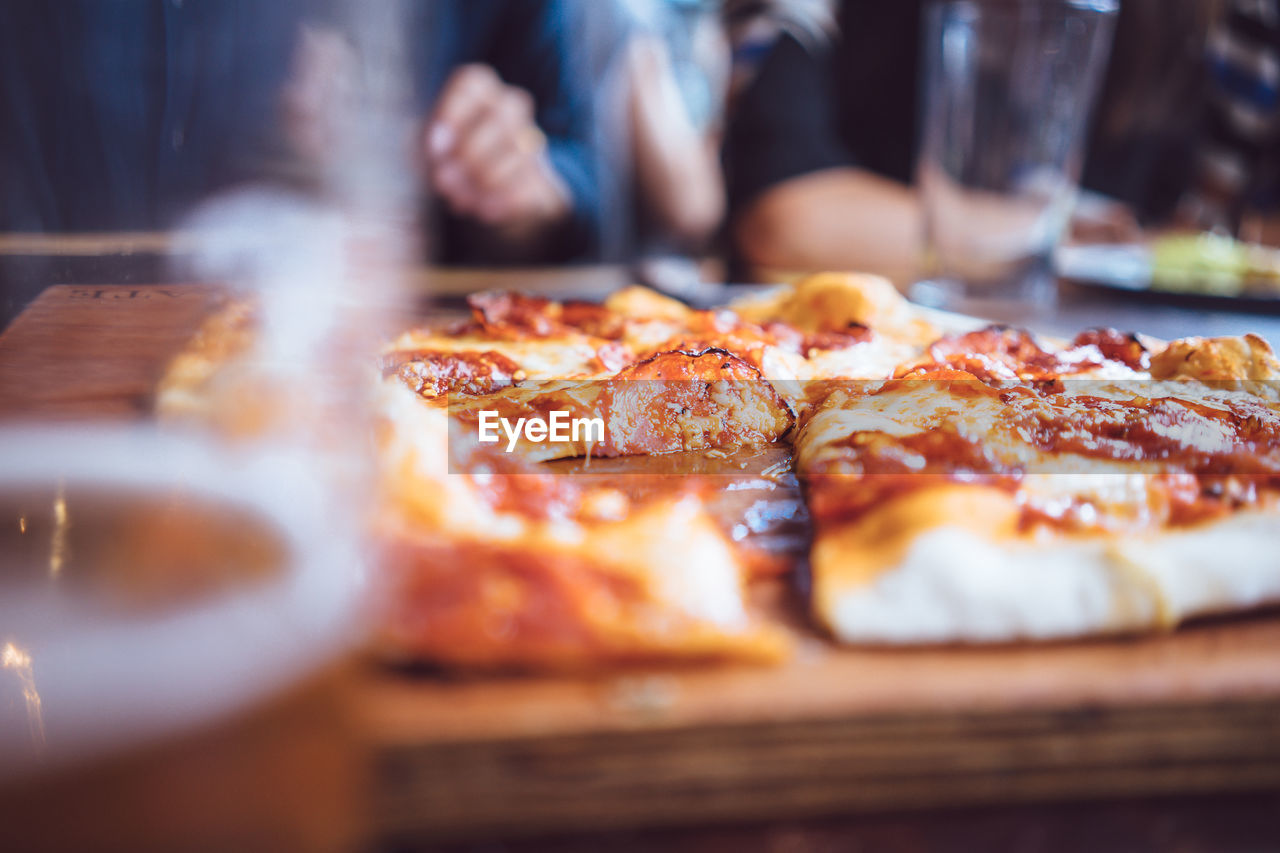 Beer and rustic pizza served on table