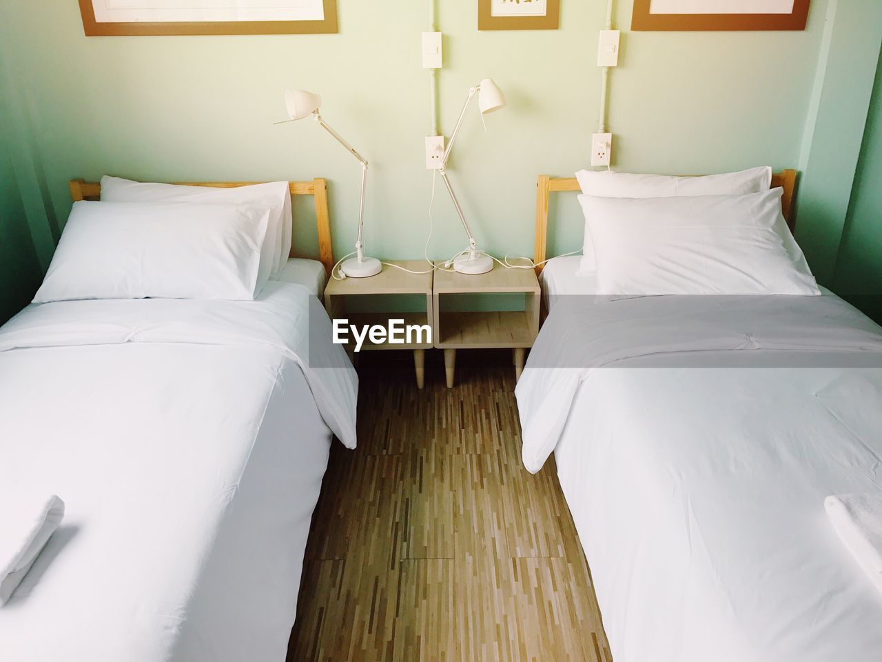 High angle view of neat beds in room