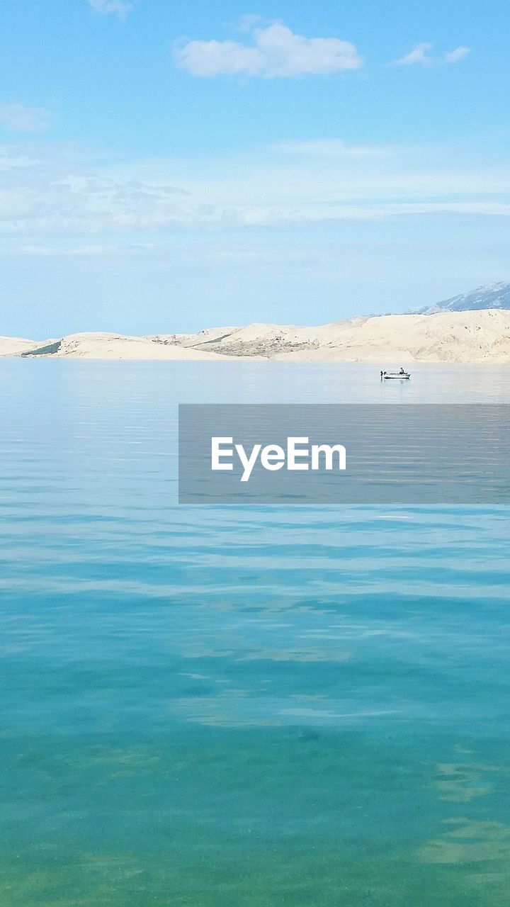 VIEW OF BOATS IN CALM BLUE SEA AGAINST SKY