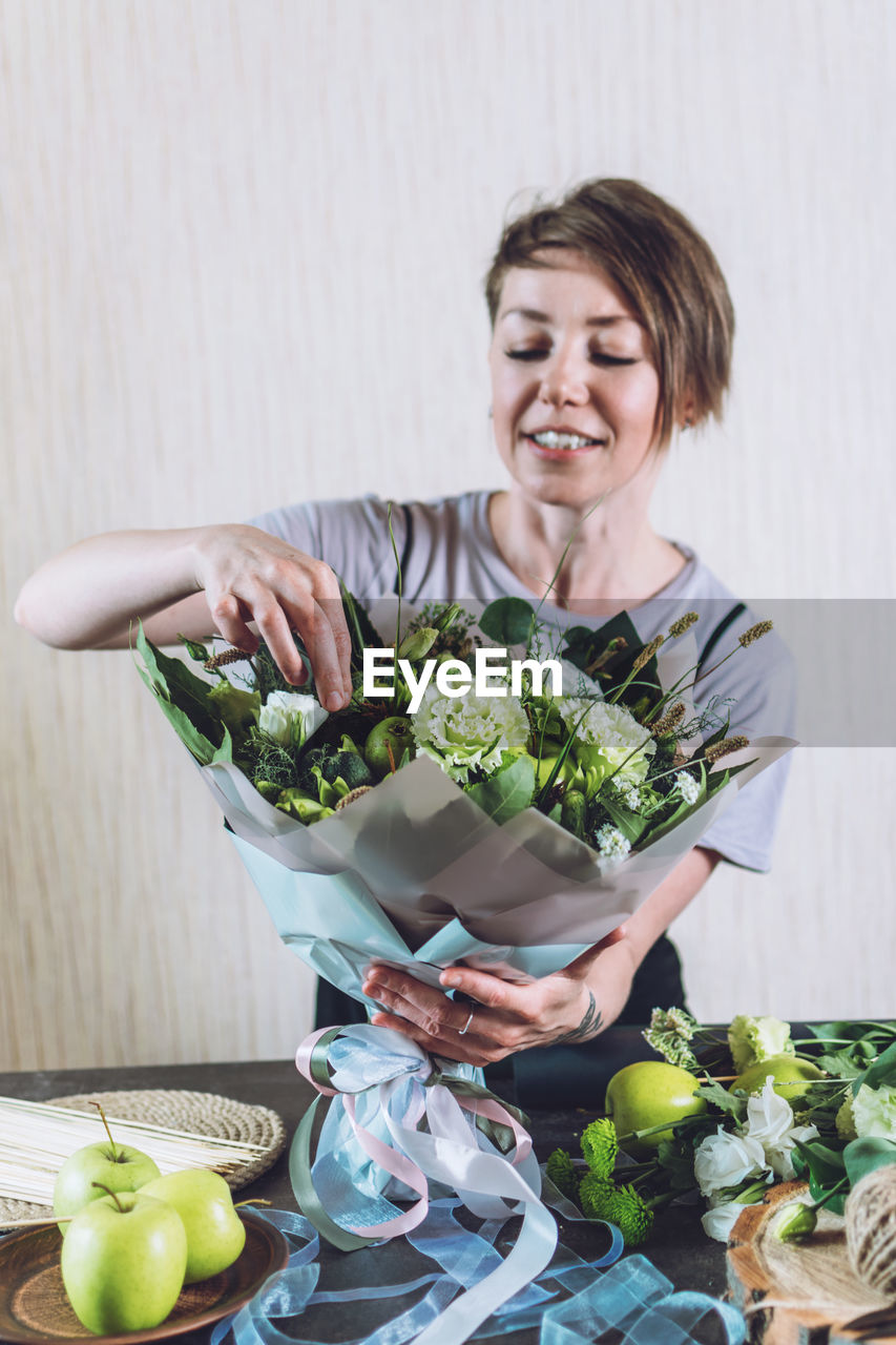 HAPPY YOUNG WOMAN WITH FRUITS