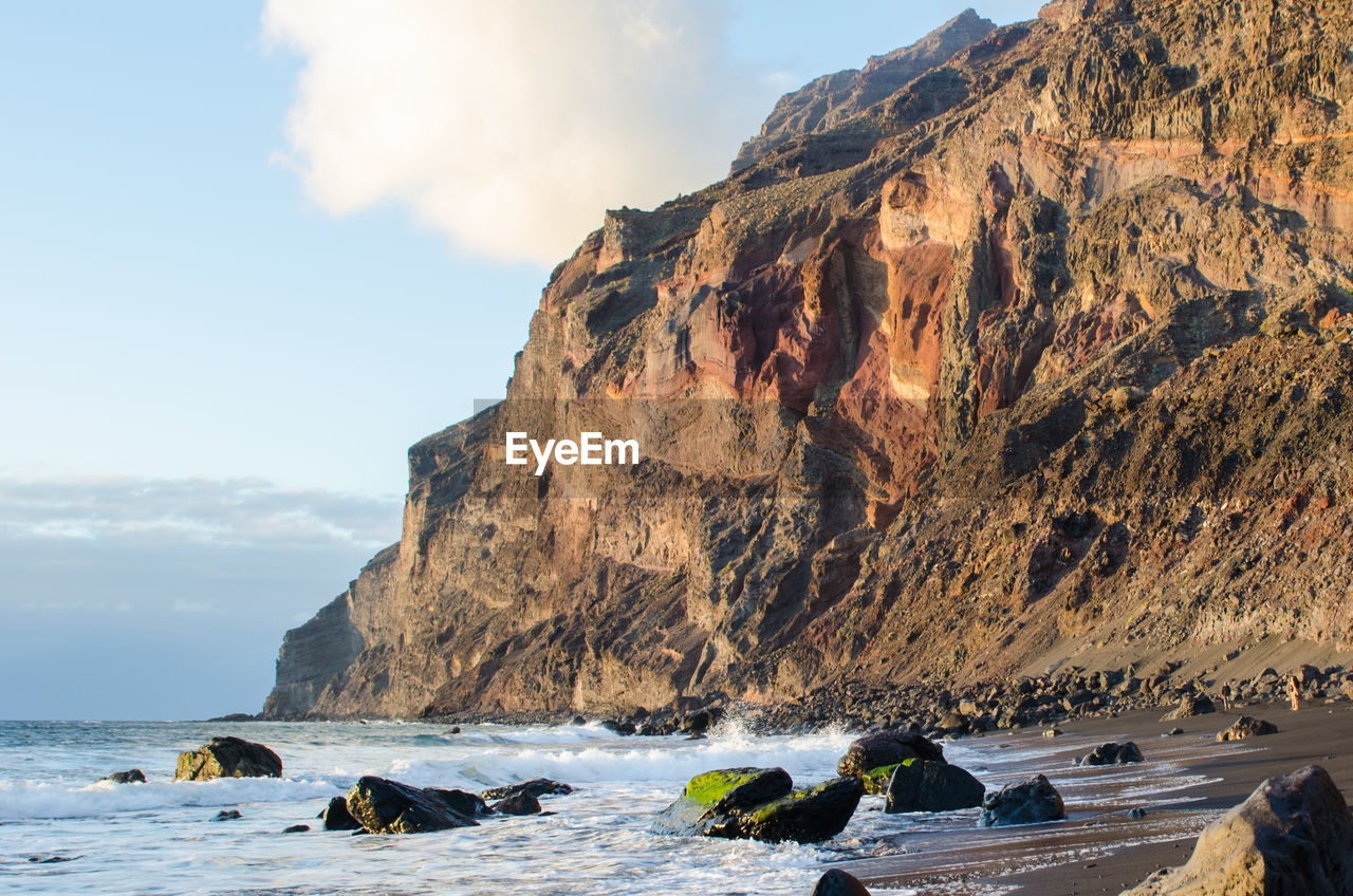 SCENIC VIEW OF SEA AND ROCKS AGAINST SKY