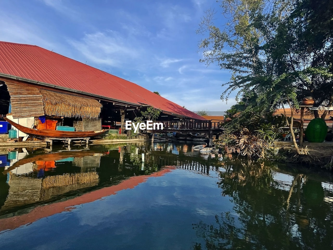 water, architecture, reflection, built structure, nature, building exterior, sky, tree, building, plant, lake, travel destinations, house, cloud, outdoors, city, day, vacation, travel, resort, transportation, nautical vessel, tourism, no people, tradition, blue, waterfront