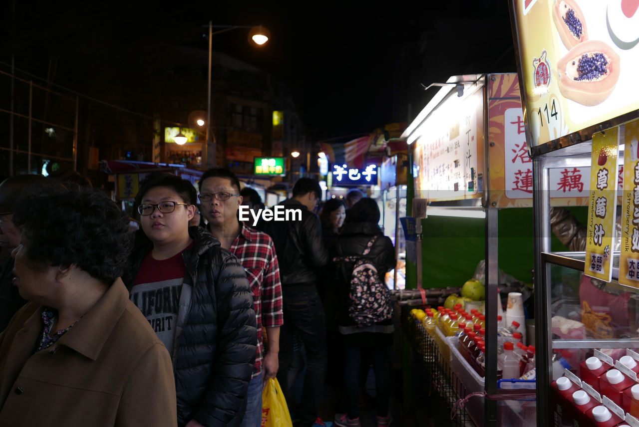 WOMAN STANDING AT NIGHT