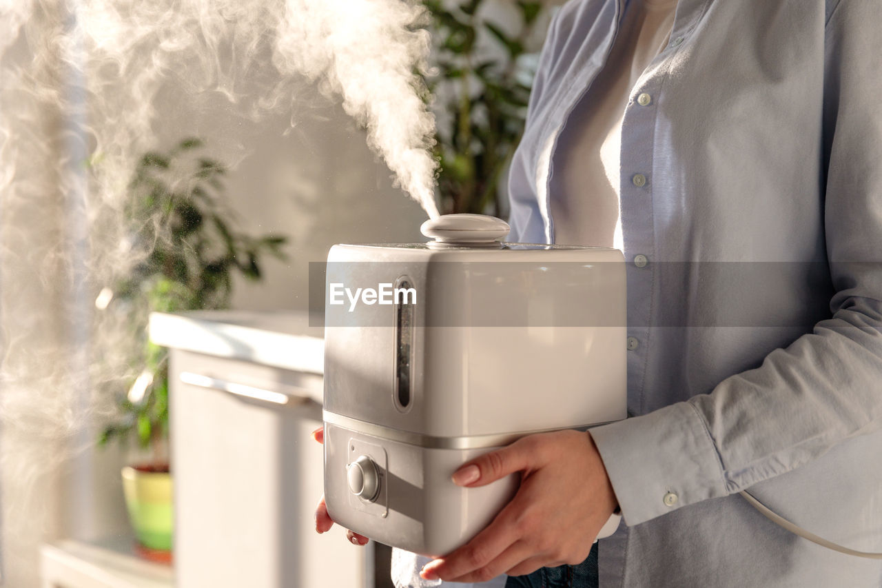 Close-up of woman holding humidifier