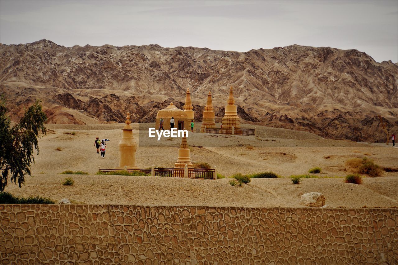 Scenic view of pagoda in desert against sky