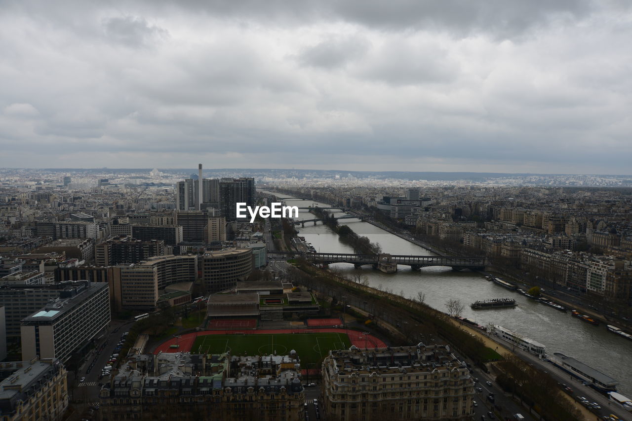 High angle view of seine river in city against cloudy sky