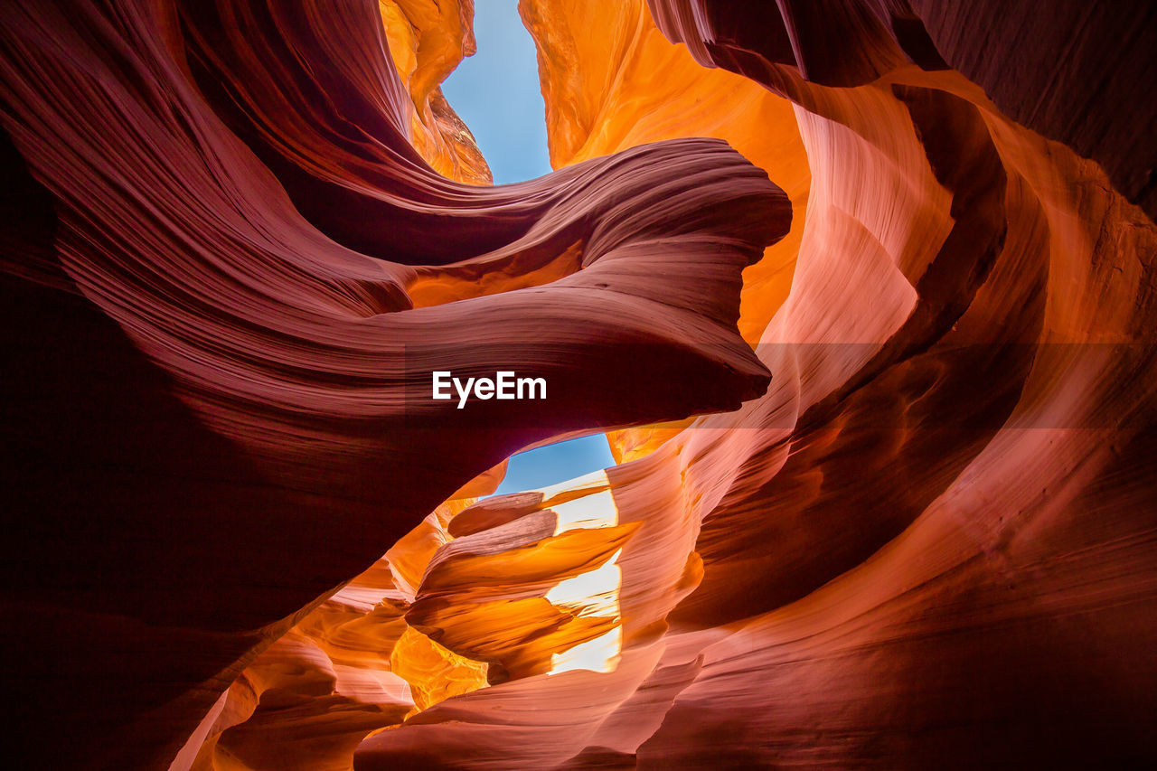 LOW ANGLE VIEW OF ROCK FORMATION IN SUNLIGHT