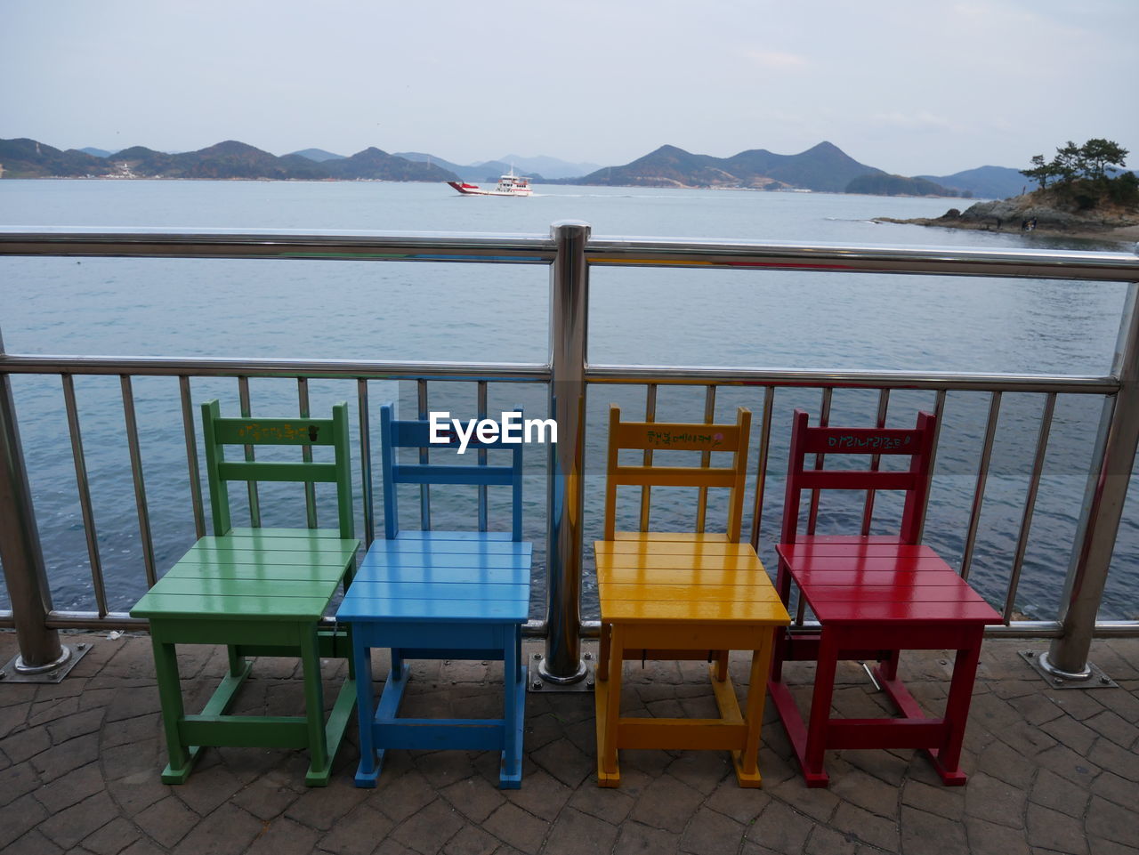 CHAIRS AND TABLE AGAINST SEA