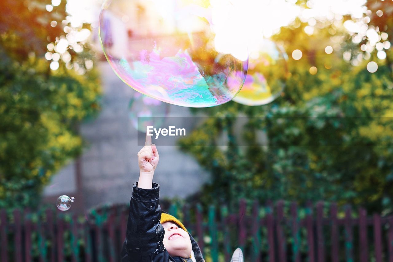 Girl playing with bubble in yard