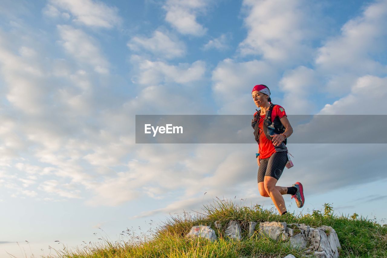 Low angle view of woman against sky