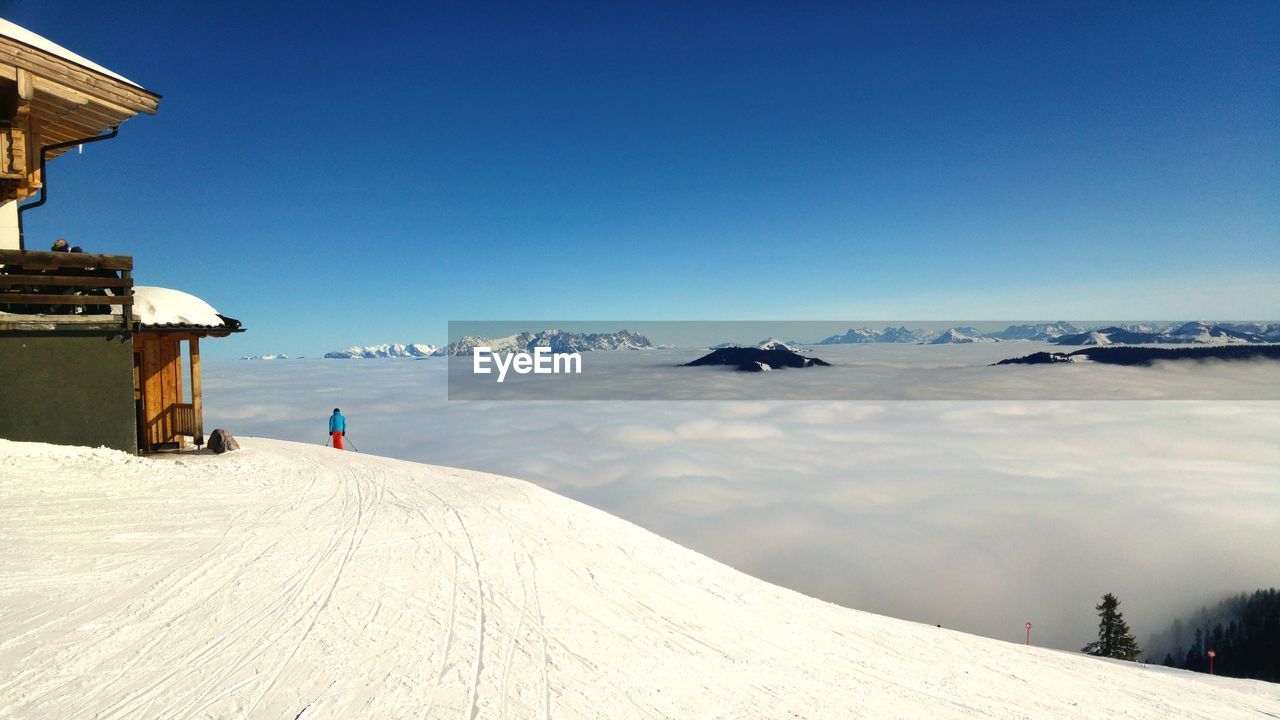 Person skiing on mountain against sky