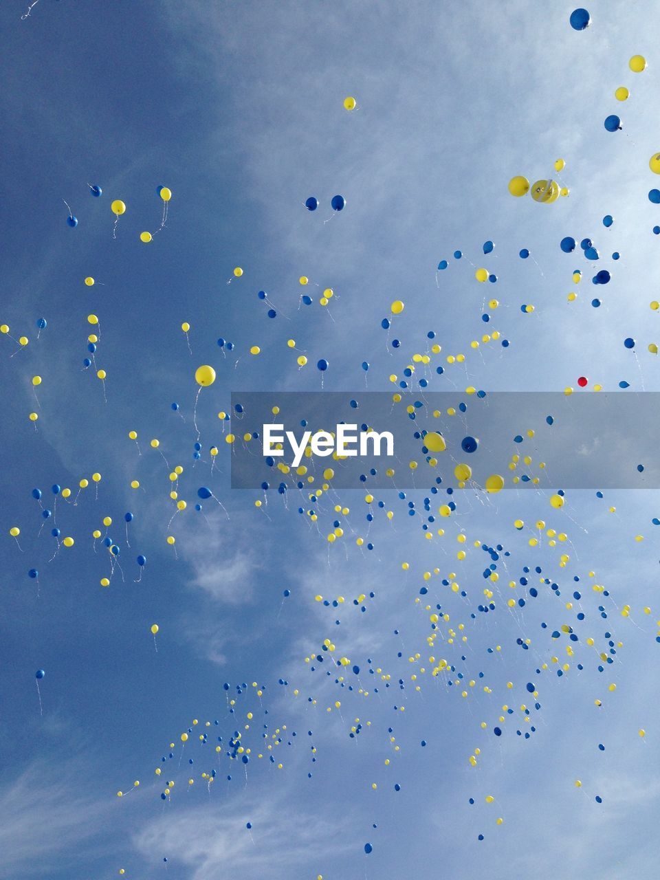 Low angle view of balloons flying against sky