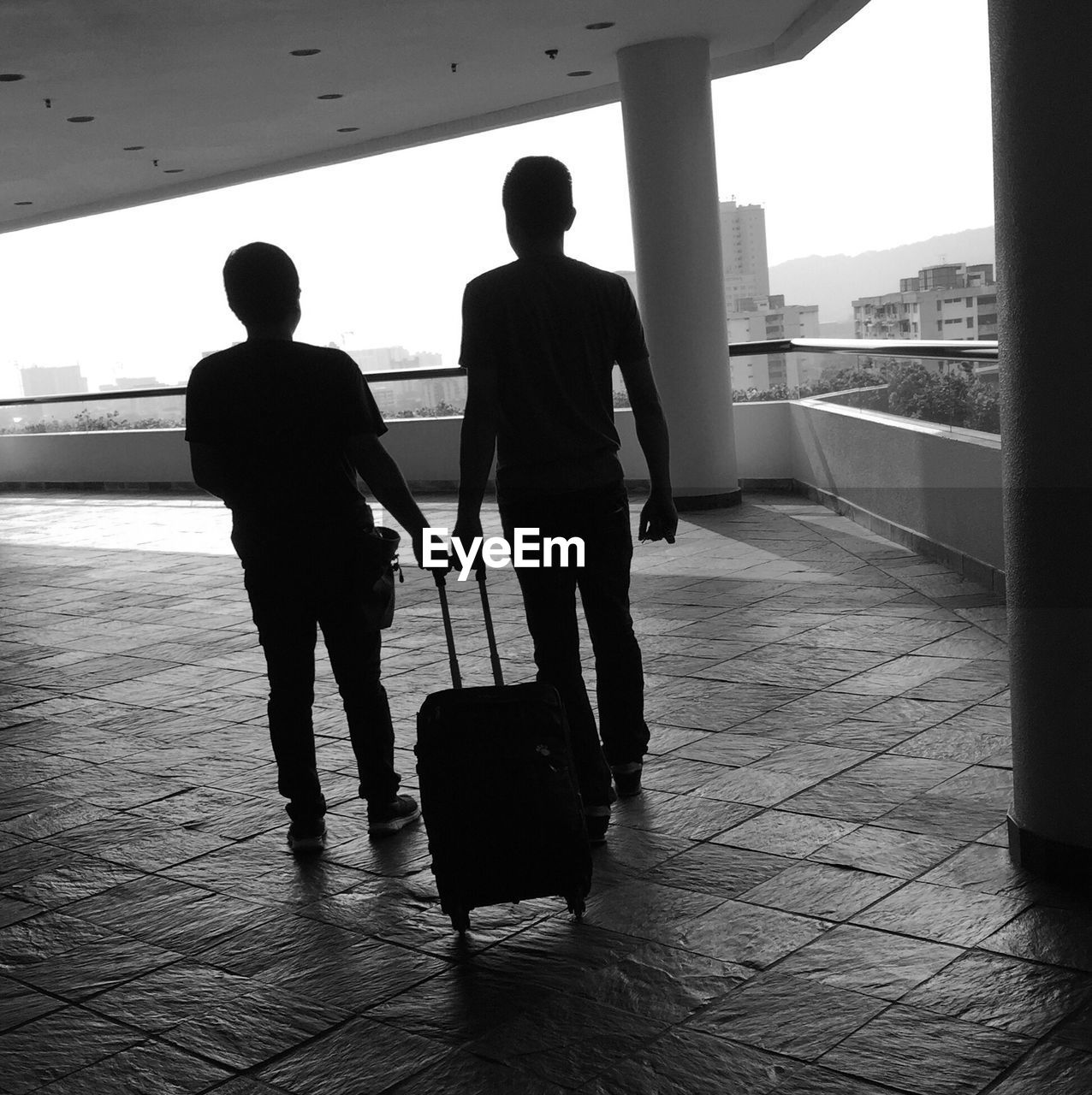 Silhouette of people standing with luggage