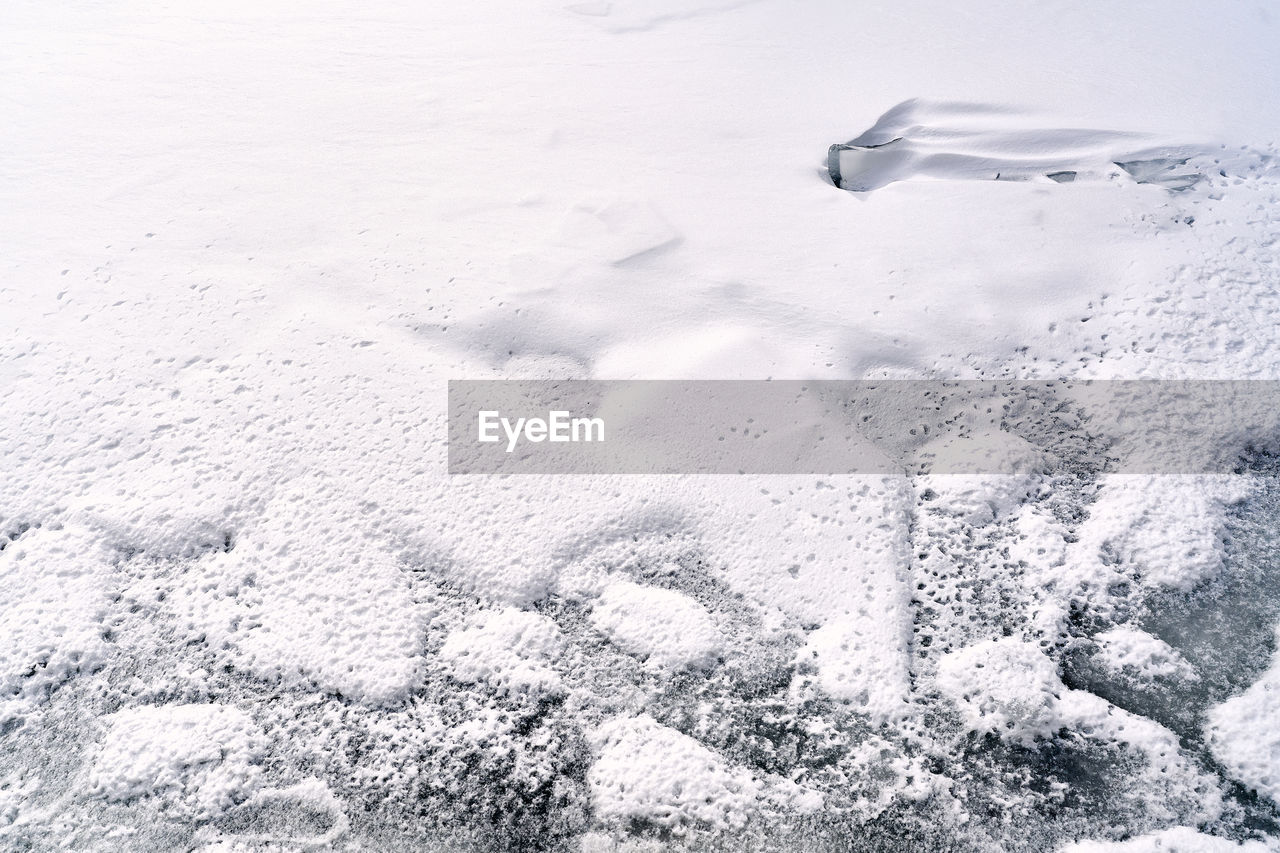 snow, winter, nature, freezing, cold temperature, water, no people, ice, day, environment, land, outdoors, beauty in nature, high angle view, frozen, blizzard, black and white, sea, scenics - nature, white, landscape, monochrome