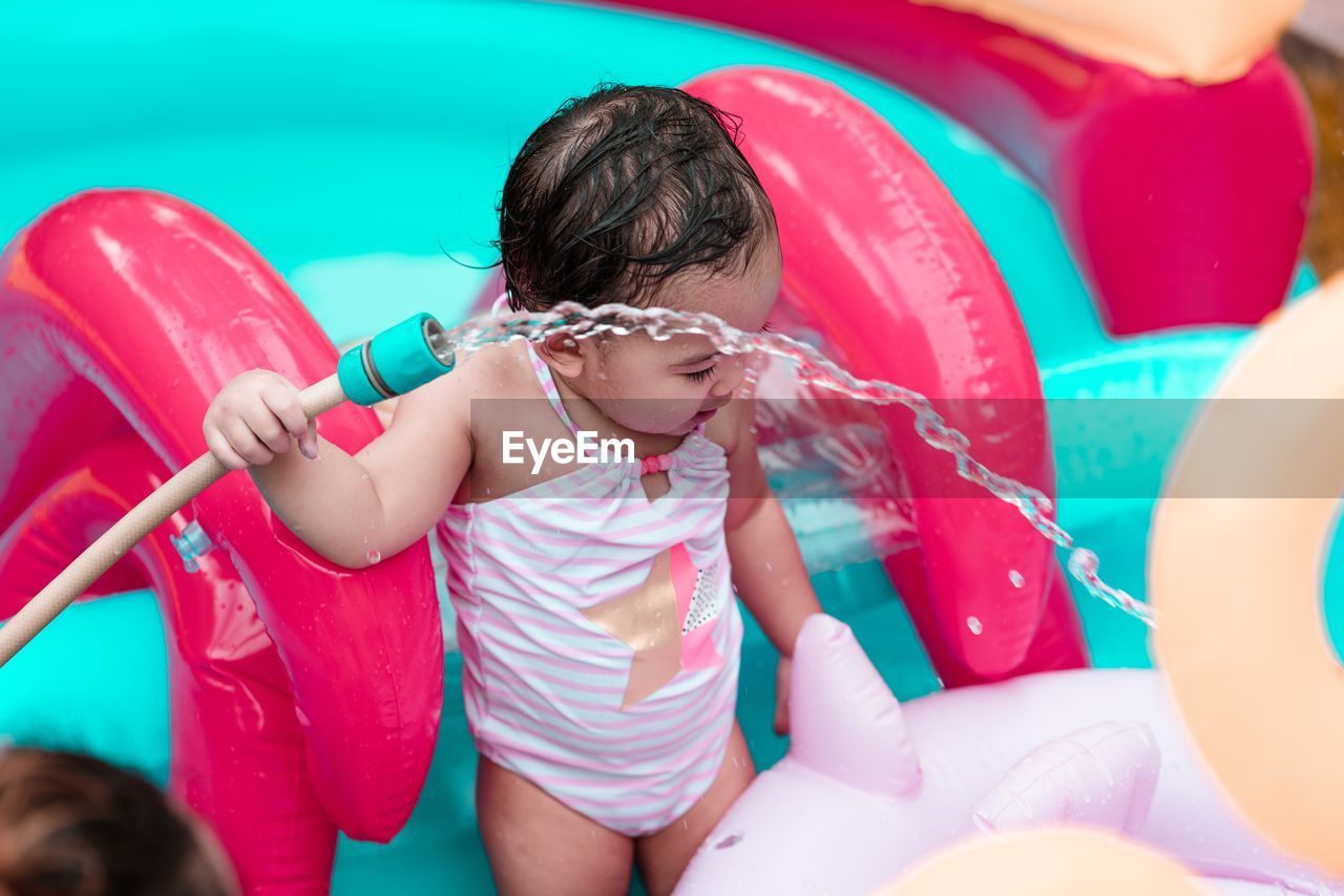 Cute girl playing in swimming pool