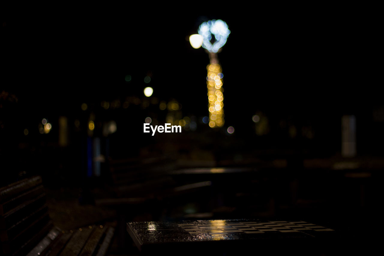 REFLECTION OF ILLUMINATED BUILDINGS ON WET TABLE