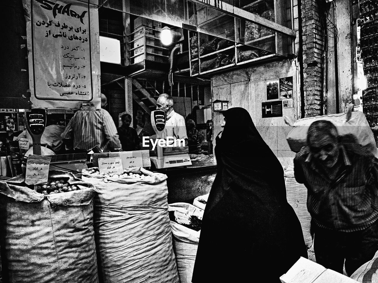 PEOPLE AT MARKET STALL