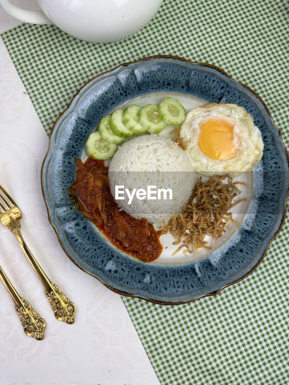 High angle view of food in plate on table known as nasi lemak