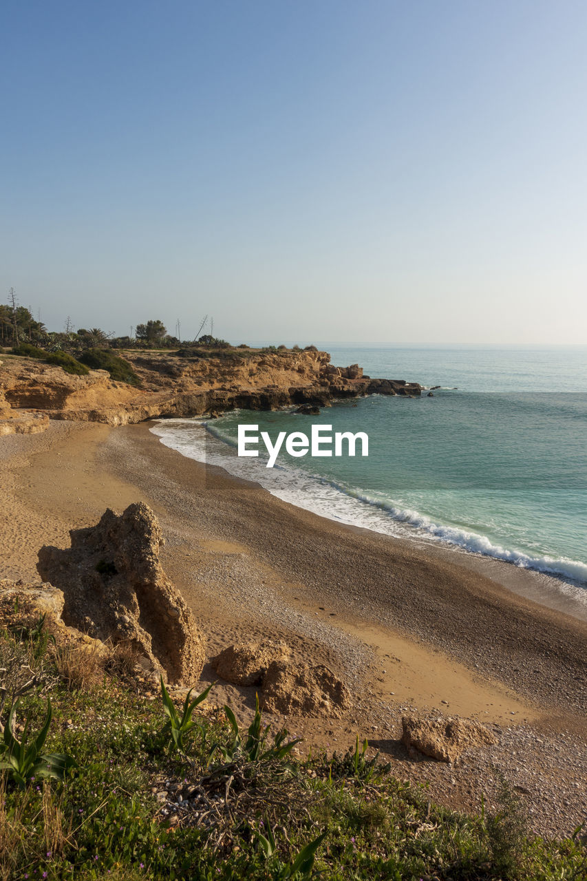 Scenic view of beach against clear sky