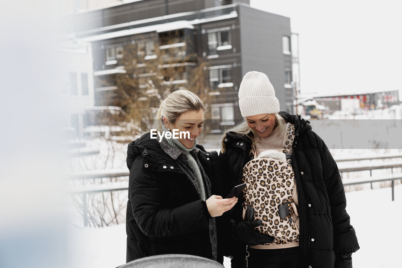 Female couple walking together at winter