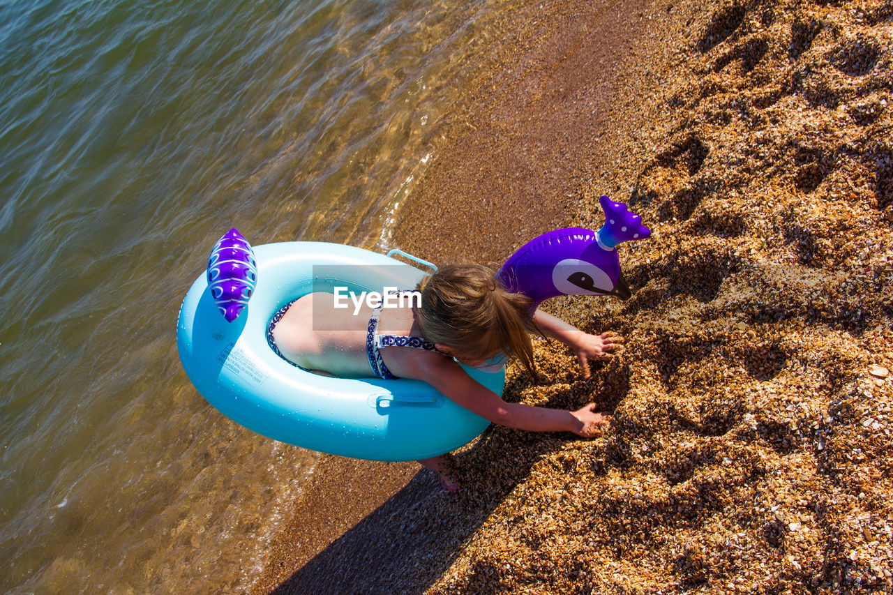 HIGH ANGLE VIEW OF GIRL ON SHORE