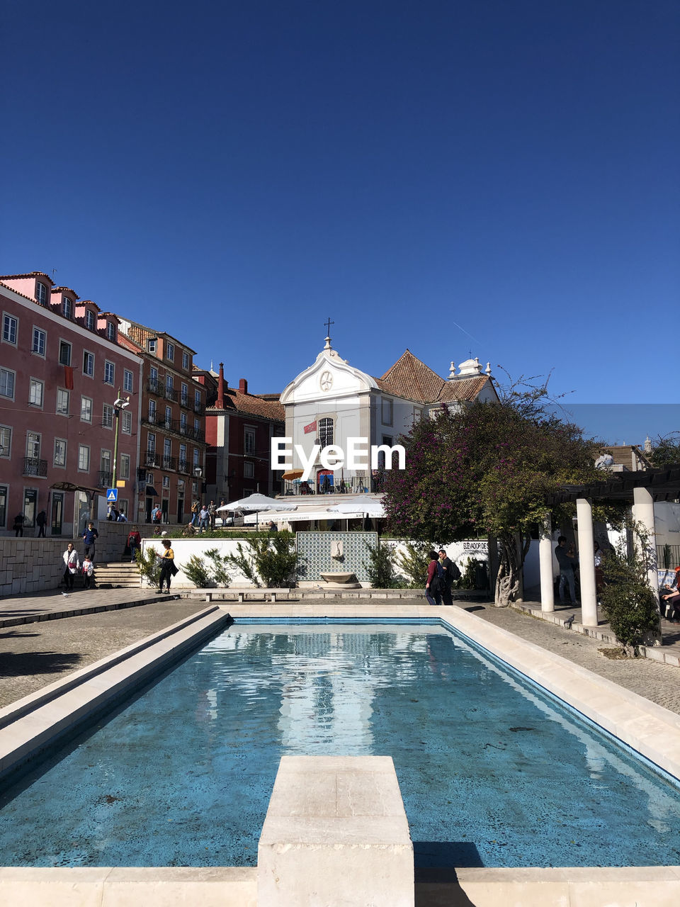 VIEW OF SWIMMING POOL AGAINST BUILDING