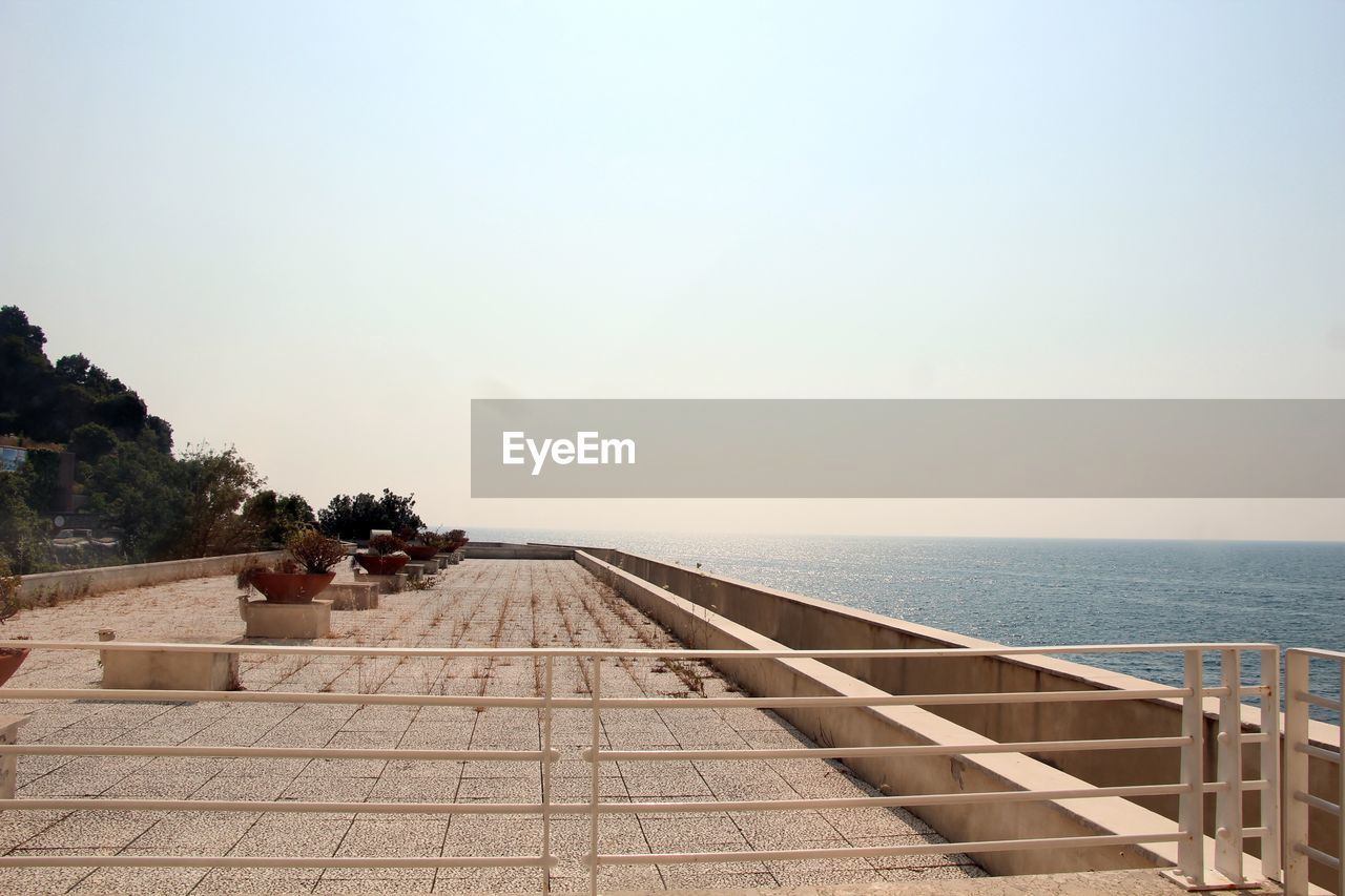 SWIMMING POOL BY SEA AGAINST CLEAR SKY