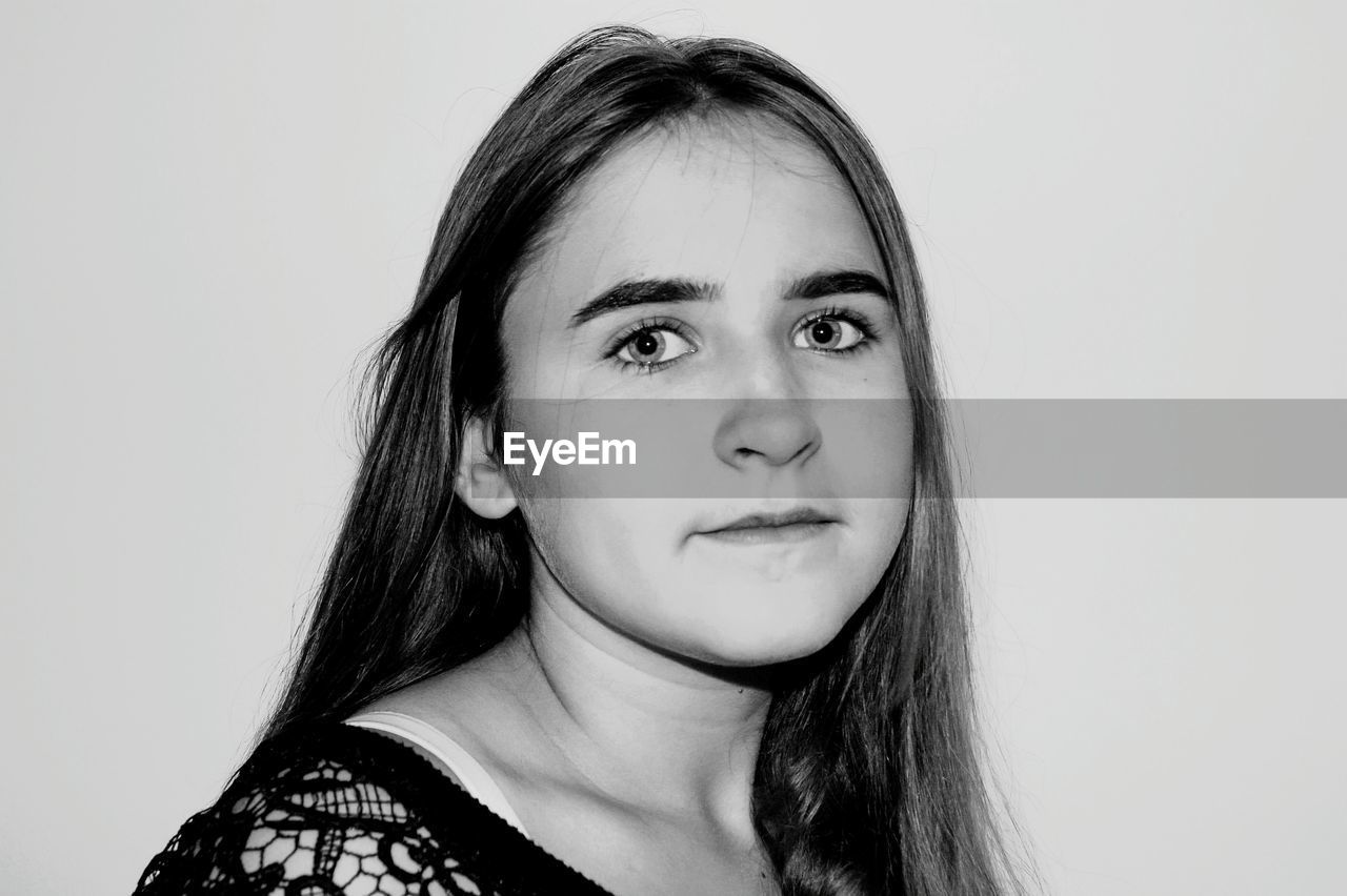 Portrait of woman against white background