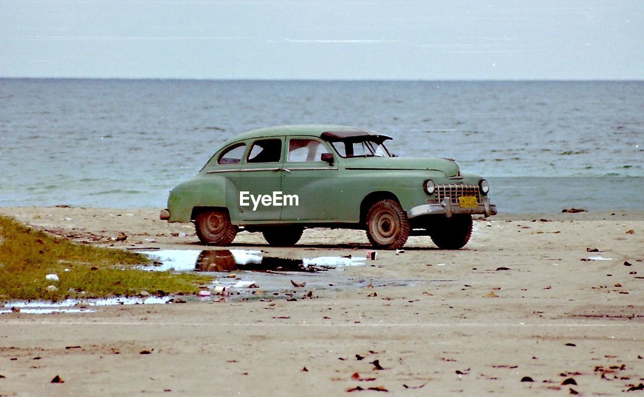 TOY CAR ON BEACH