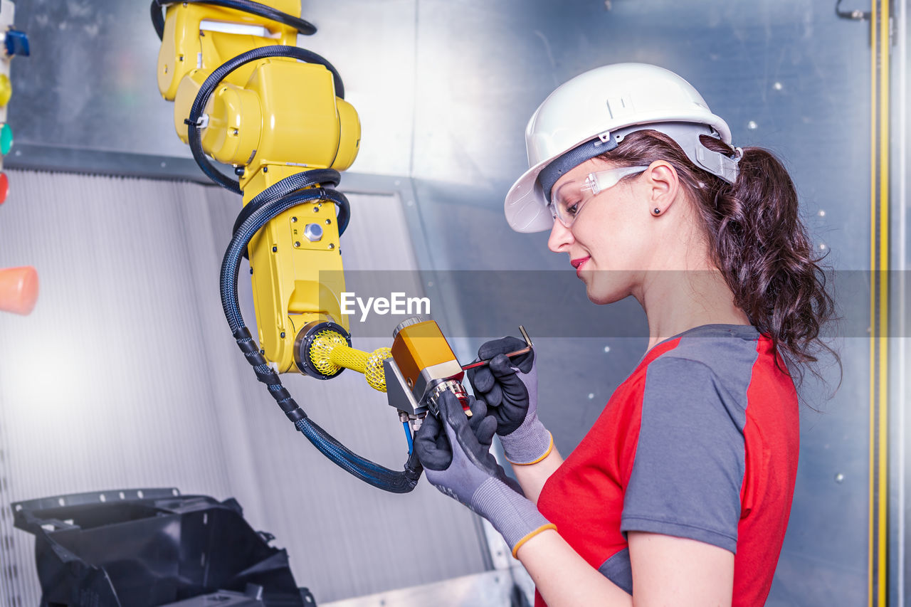 Technician working on machinery in factory